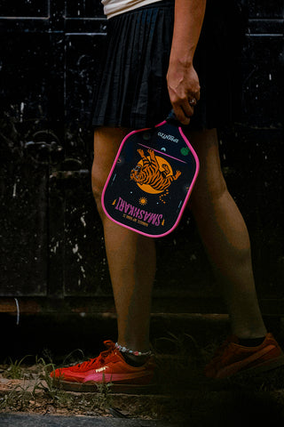Pickleball paddle with a tiger design outdoors